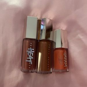 Fenty Beauty lipglosses in fussy heat, peach pout, fenty glow